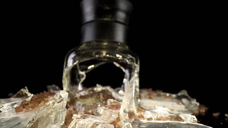 slowly pushing towards a broken sea salt grinder, top portion standing upright, wide angle macro view - travelling inside the broken glass of the grinder