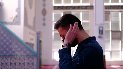 Young-Man-Worships-In-A-Mask-in-A-Mosque