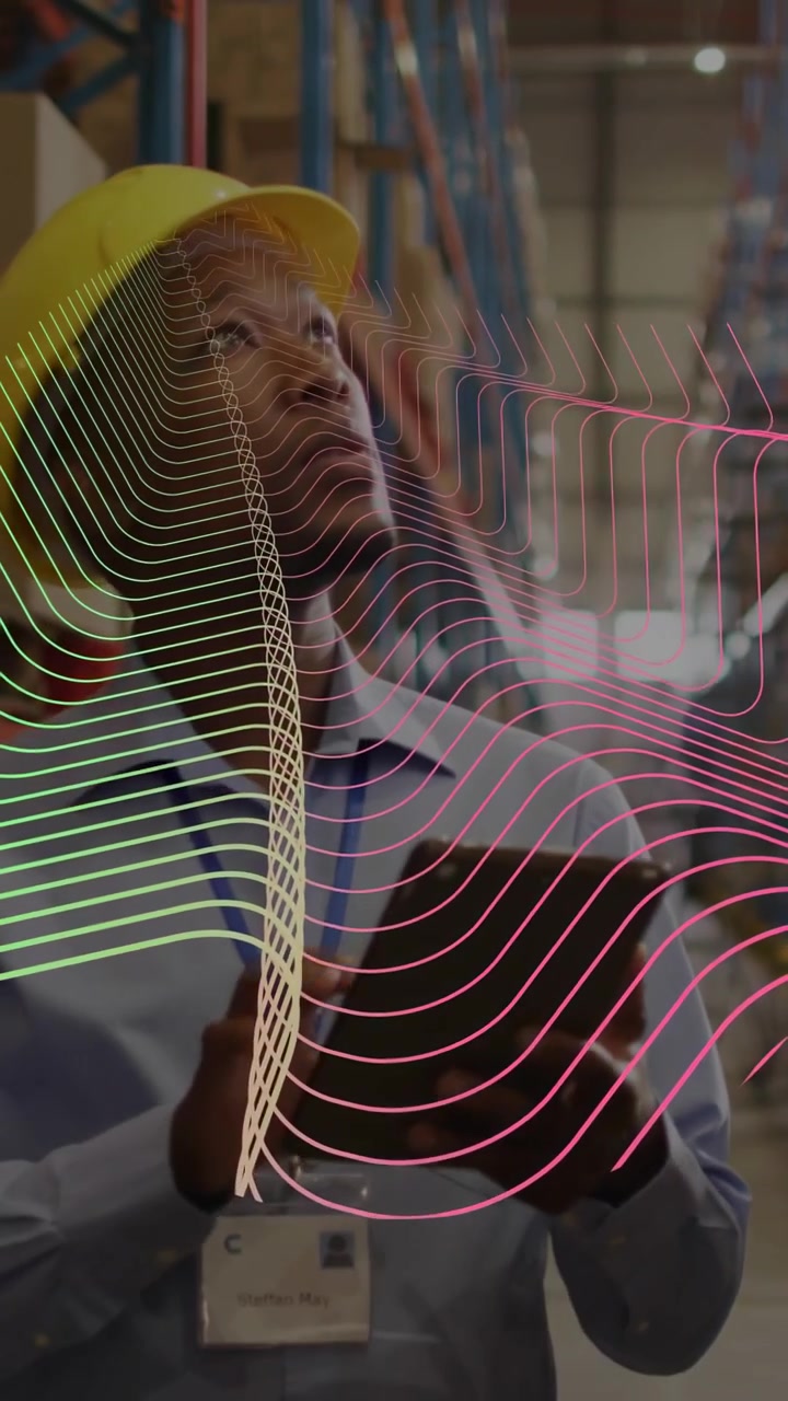 Vertical video: Warehouse lead tapping tablet, causing AR waveform layering over shelves and face