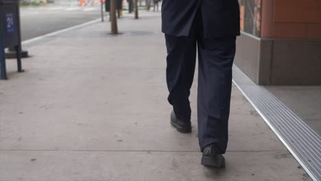 Smartly-Dressed-Man-Walking-on-Sidewalk