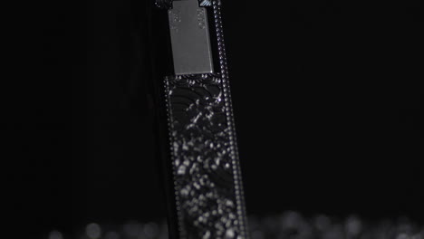 detail of a laser engraved handgun with a black backdrop. close-up shot