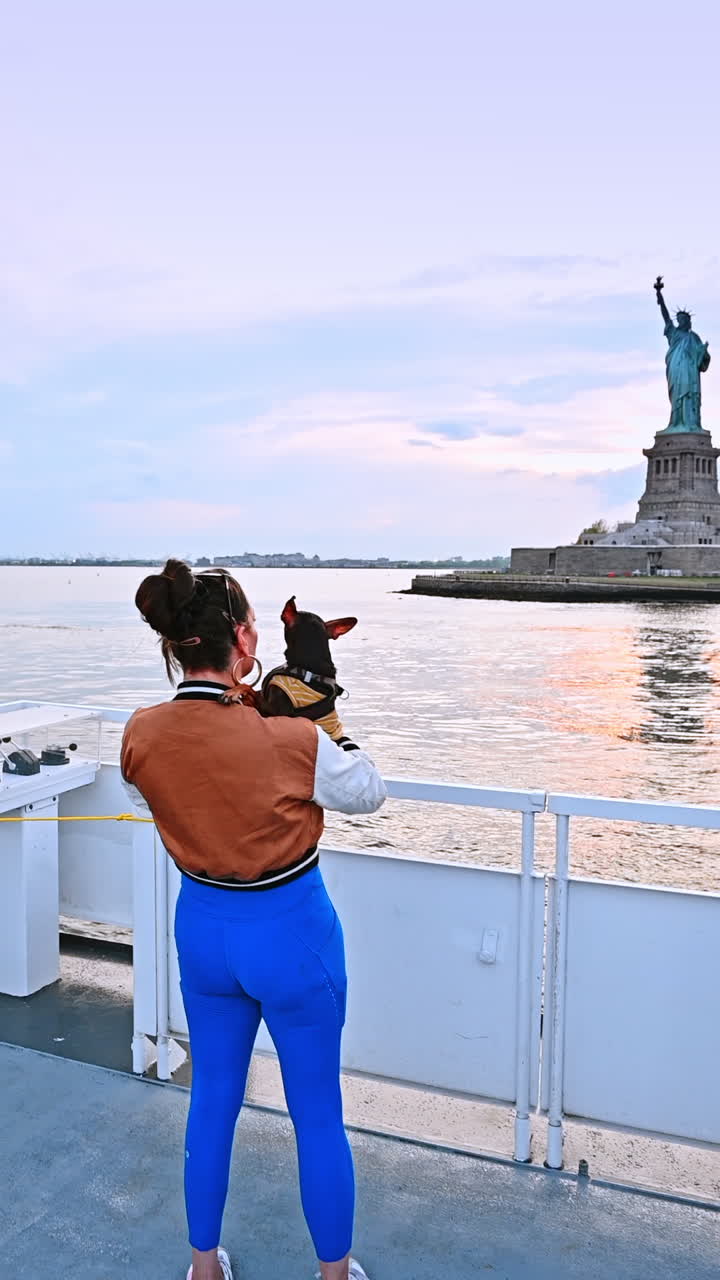 New York, USA, 8 July 2025: Enjoying sunset views in New York City. People capture the tranquil beauty of the sunset over the Statue of Liberty in New York
