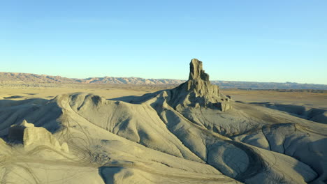 drone, aerial footage around moonscape landscape near factory butte in utah, united states