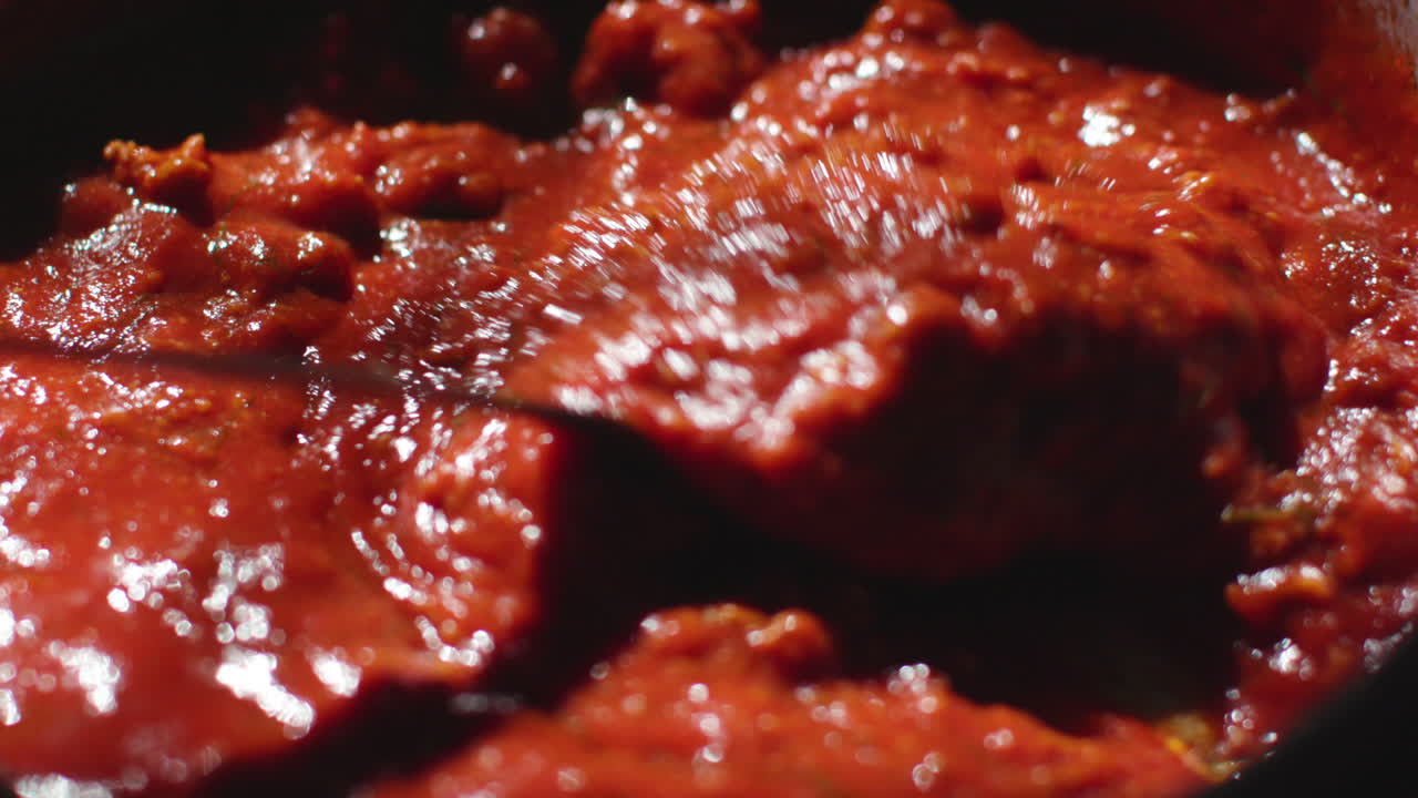 Cooking tasty tomato sauce slow motion close up