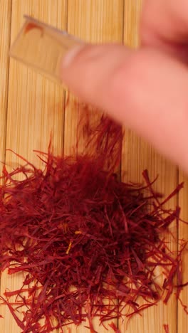 pouring pile of saffron threads onto table