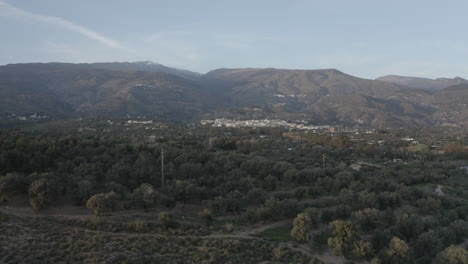 rising reveal of a spanish village amongst the mountains and blue sky.