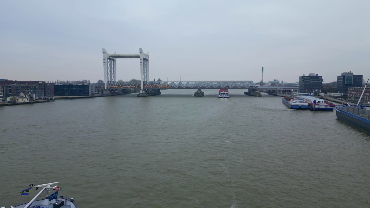 네덜란드의 도르드레흐트 철도 교량을 향해 오우데 마스 강에서 순항하는 바지선