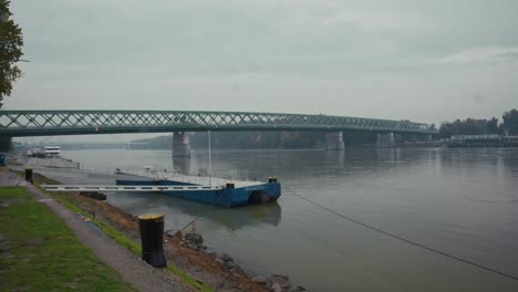steel truss bridge spanning the danube river in bratislava under cloudy skies