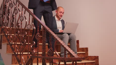 tired entrepreneur smoking and working on stairs