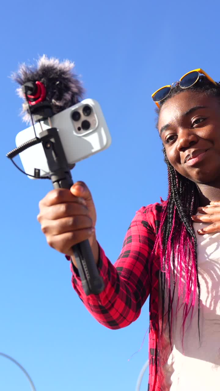 Woman Vlogging Outdoors with Smartphone and Microphone