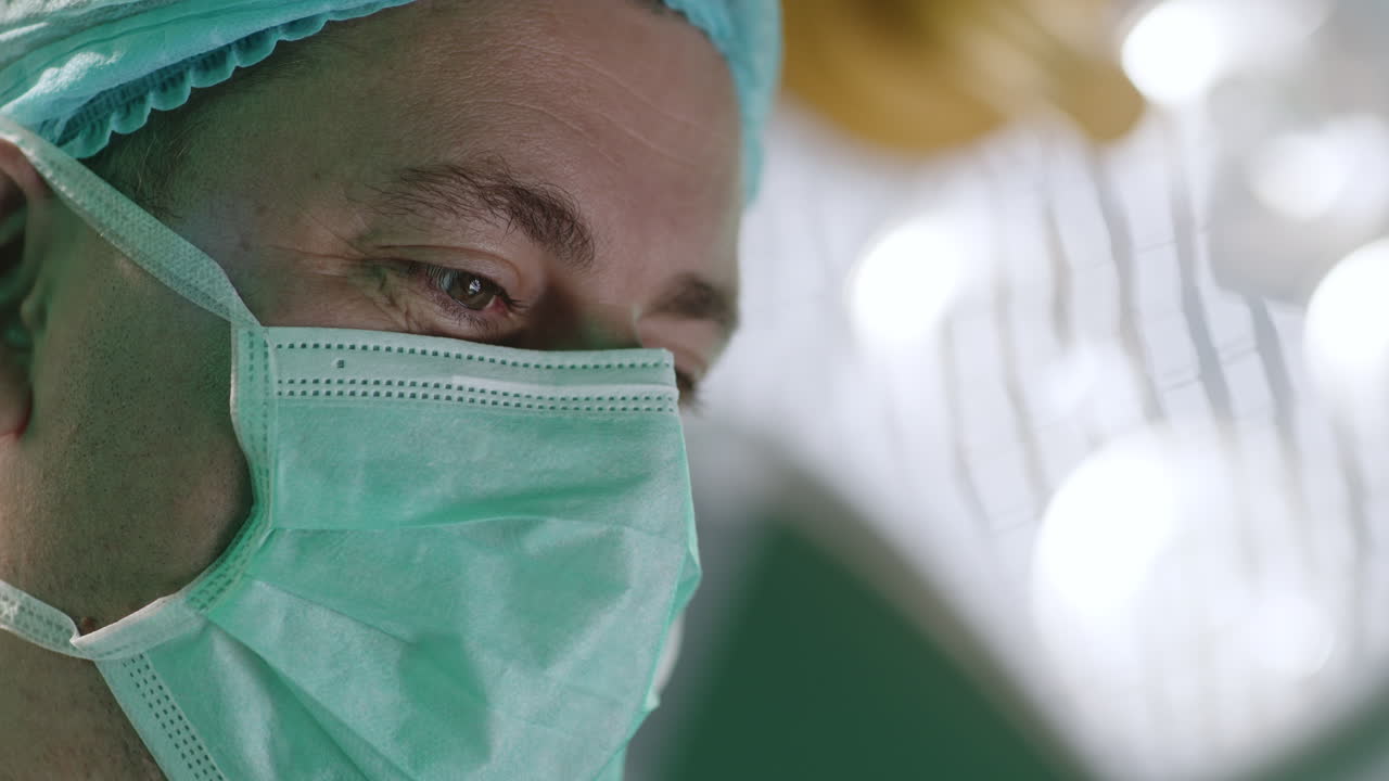 Surgeon wearing a mask and cap