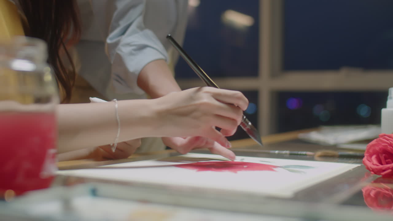 Asian Woman Painting with Teacher during Art Class