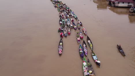 Above-traditional-Lok-baintan-floating-market-Kalimantan-on-brown-river,-aerial
