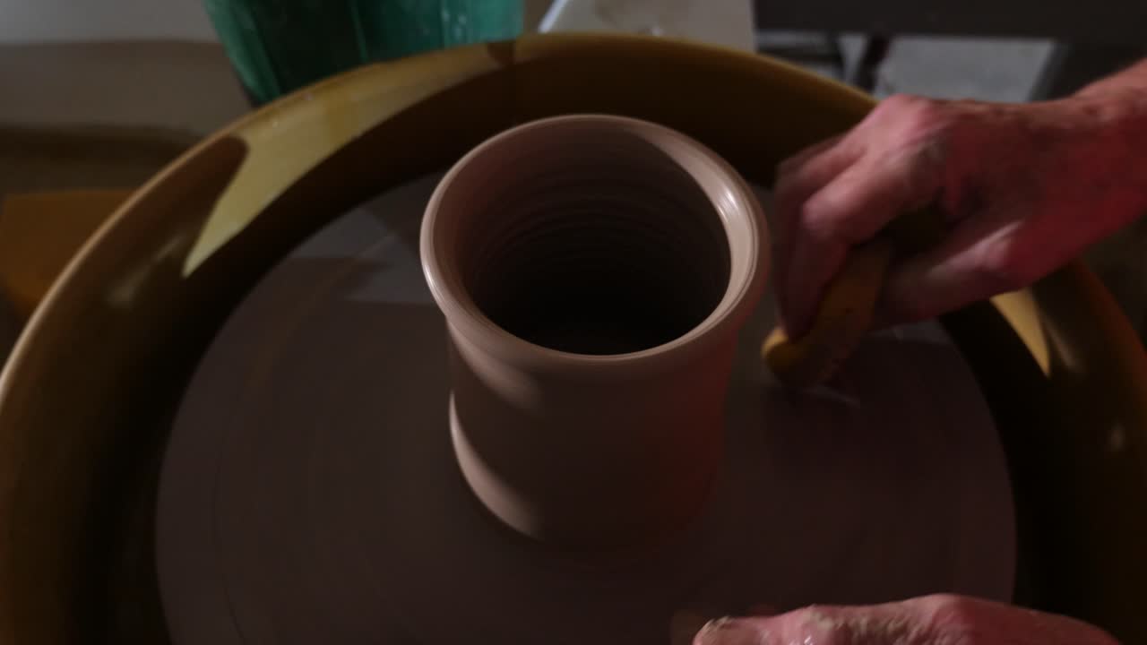 Artista che modella ceramiche con l'argilla al tornio