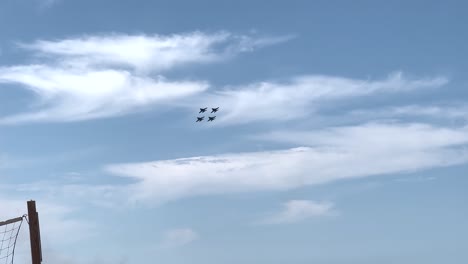 four blue angel jets flying in formation over grand traverse bay in traverse city, michigan