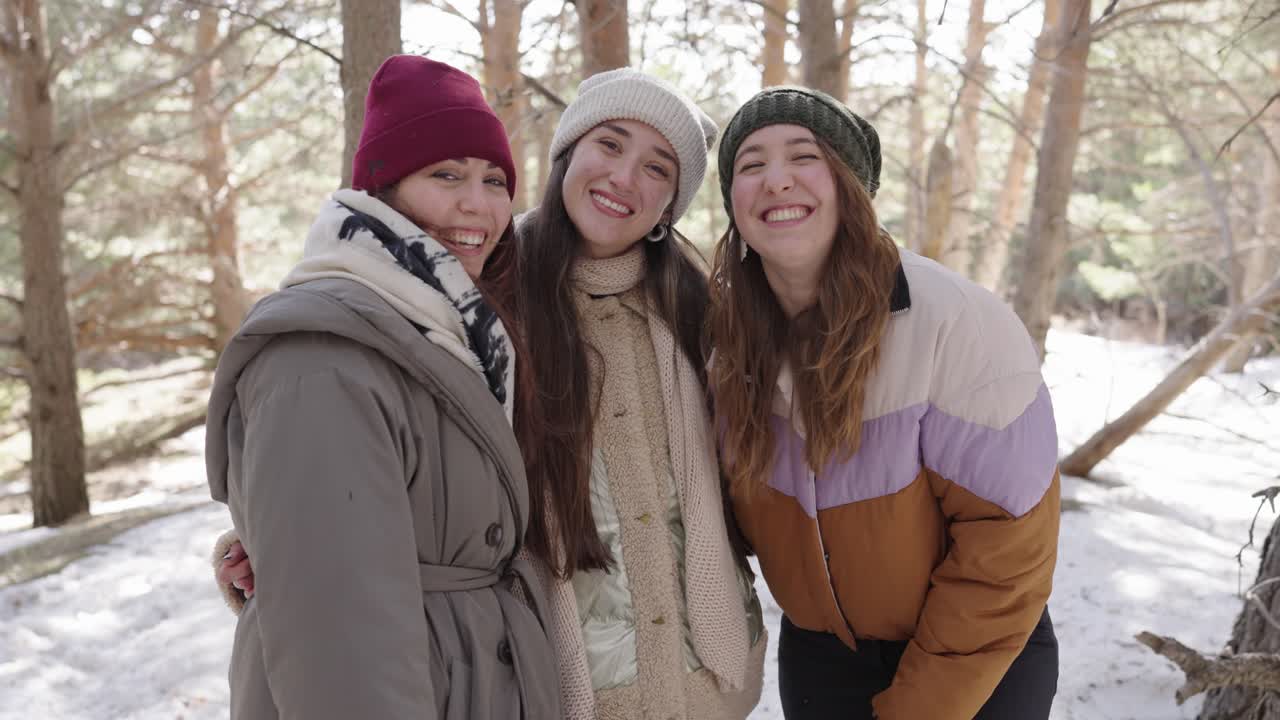 Three Women Laughing in a Snowy Forest