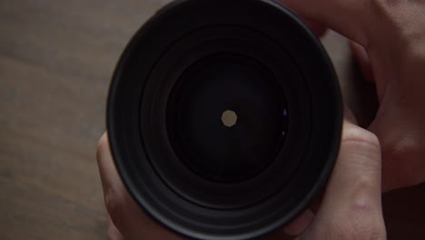 Front-of-camera-lens-showing-the-opening-and-closing-of-aperture,-close-up