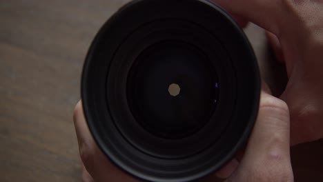 front of camera lens showing the opening and closing of aperture, close up