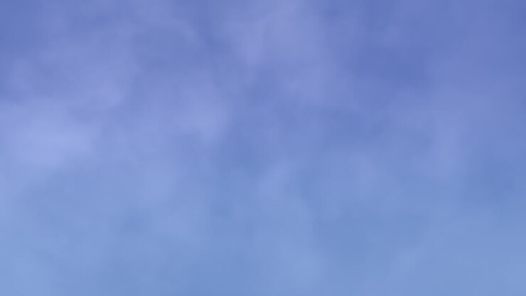 levendige blauwe lucht met stralende zon en golvende wolken