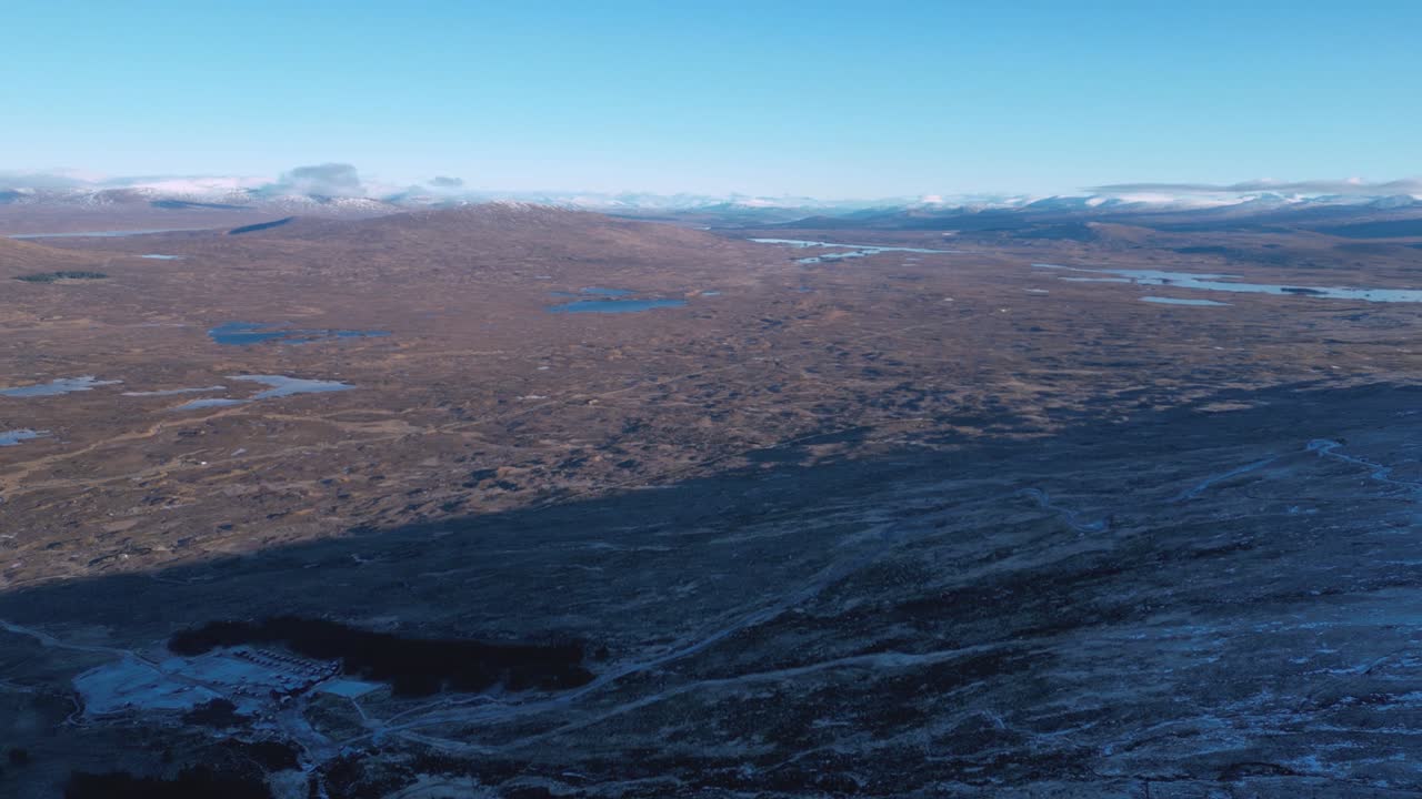 paisaje escarpado de glencoe con lagos esparcidos bajo cielos azules, vista aérea