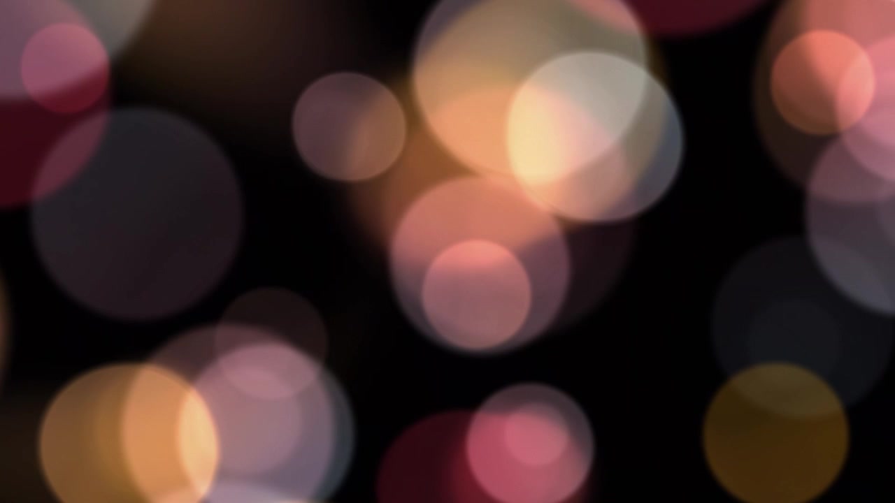 Colorful Bokeh Circles Floating and Shimmering on a Dark Background