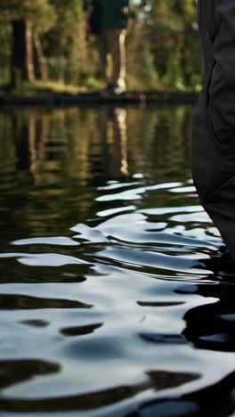 person walking in a pond