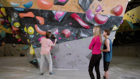 Three-friends-in-a-climbing-gym