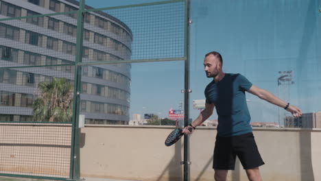 padel tennis player does a handback shot