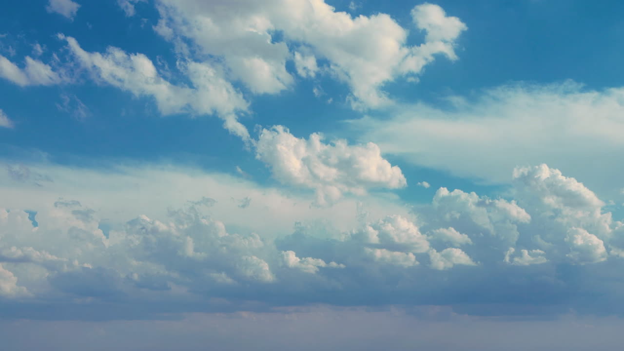 Serene Blue Sky with Fluffy White Clouds Drifting