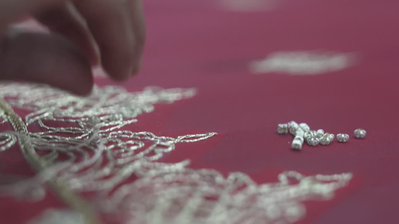 Beads Being Stitched By Hand With Cotton Thread Onto Beautiful Sari Wedding Dress