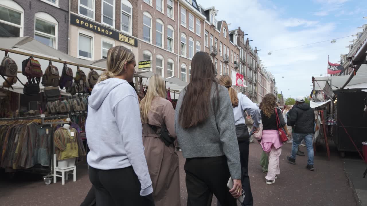 Bustling De Pijp Market in Amsterdam, Netherlands, with shoppers and vibrant stalls