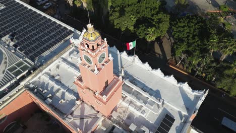 Aerial:-Flag-of-Mexico-flutters-on-Merida-City-Hall-by-Plaza-Grande