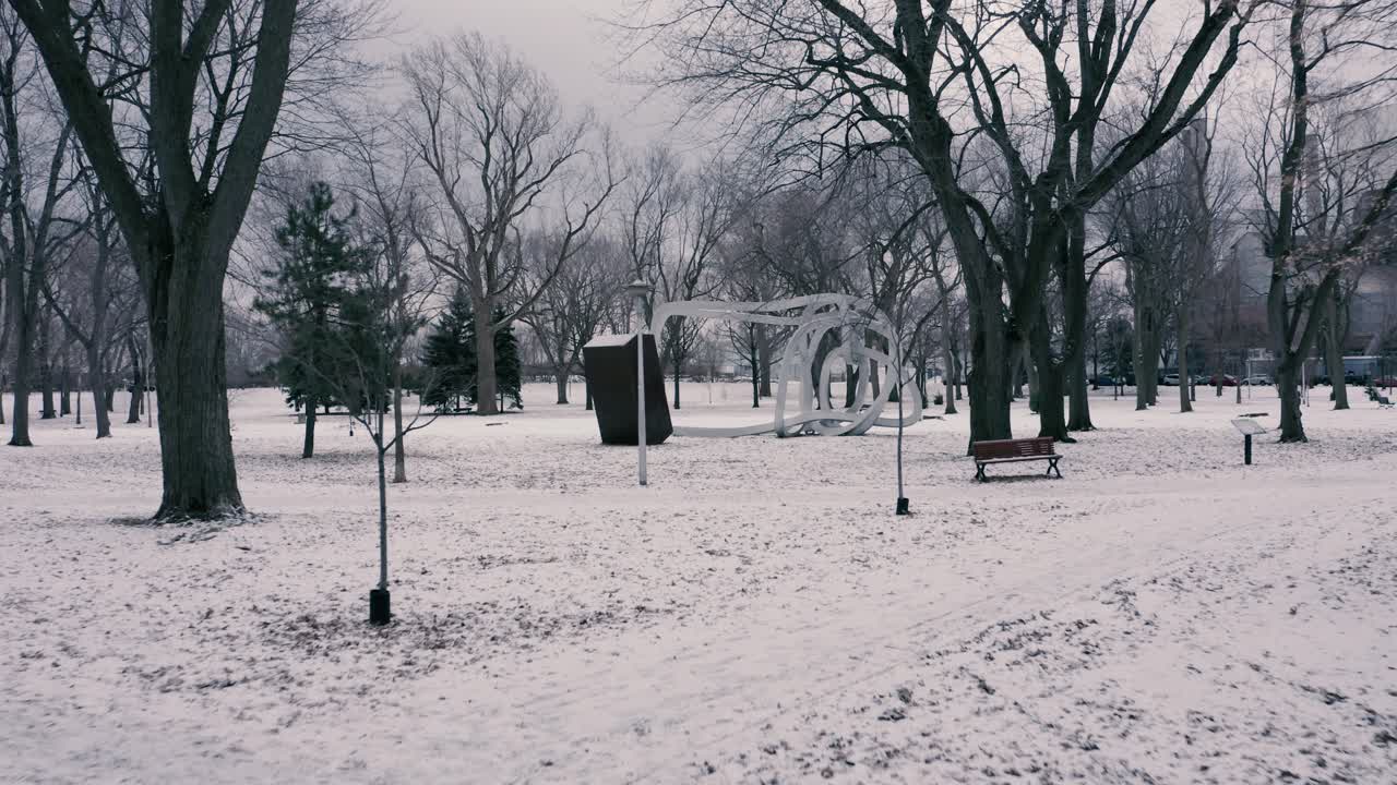 Snowy Winter Park with Sculpture