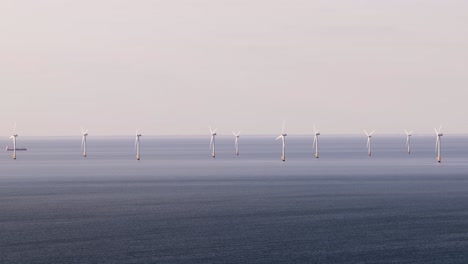 whitstable wind farm on calm sea, renewables and serenity