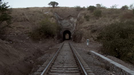 railroad tracks and tunnel alongside the country
