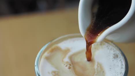 vertiendo espresso en un latte