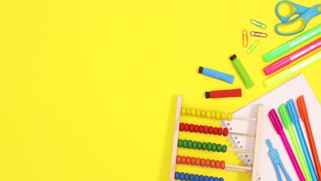 vibrant school stationery appear on right side of yellow theme. stop motion