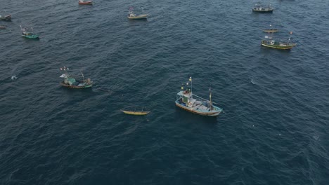 aerial drone shot of anchored fishing boats out at sea