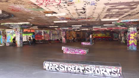 skateboarder performing tricks in urban skatepark