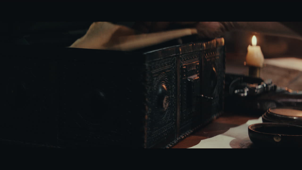 An old captain opens an old document chest inside the sailing ship cabin