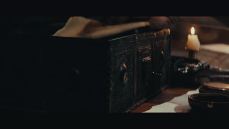 an old captain opens an old document chest inside the sailing ship cabin