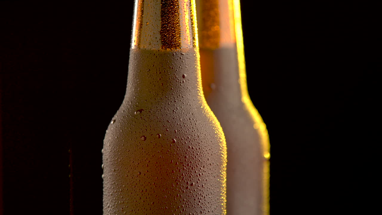 Two beer bottle rotating on white background