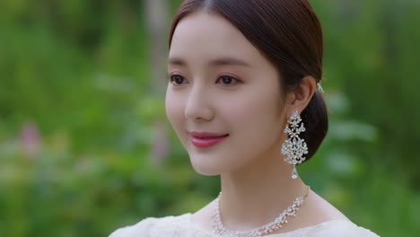 elegant woman with diamond jewelry in a garden setting