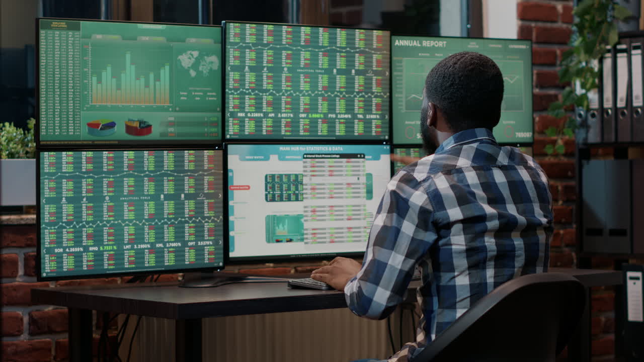 African american broker using trade market charts and graphs
