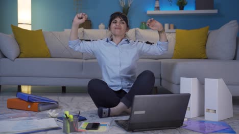 Home office worker woman yawns and relaxes at the camera.