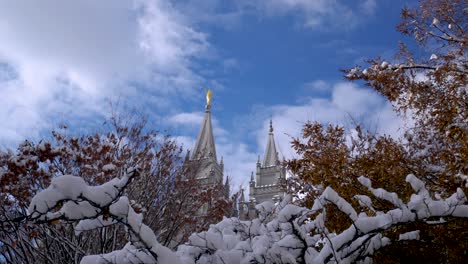 the lds mormon temple in salt lake city, utah after a snow storm on a clear morning - panning left