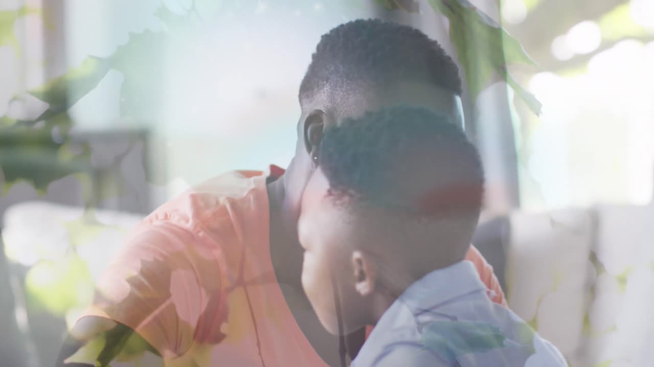 행복한 아프리카계 미국인 아버지와 아들이 소파에서 포옹하는 잎의 애니메이션