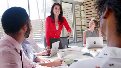 A-meeting-held-in-a-modern-office-by-a-female-boss