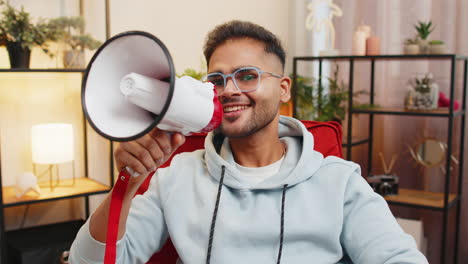 indian man talking with megaphone proclaiming news loudly announcing advertisement promotion sale