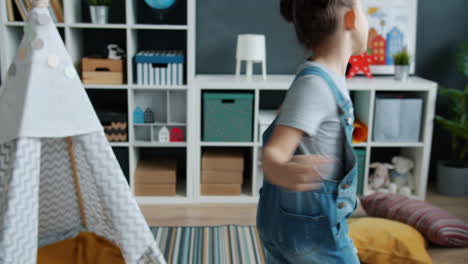 happy girl dancing in a playroom
